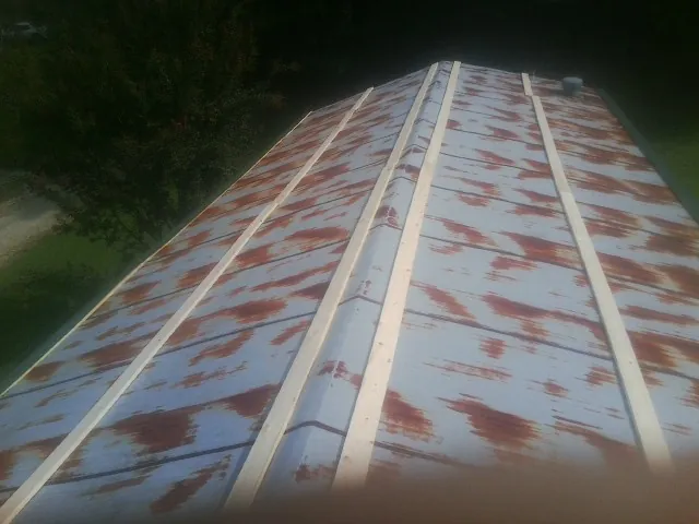Rusted metal roof panels with new wood purlins before replacement — Storm Damage Roof Repair in Kimballton by Roofing Brothers
