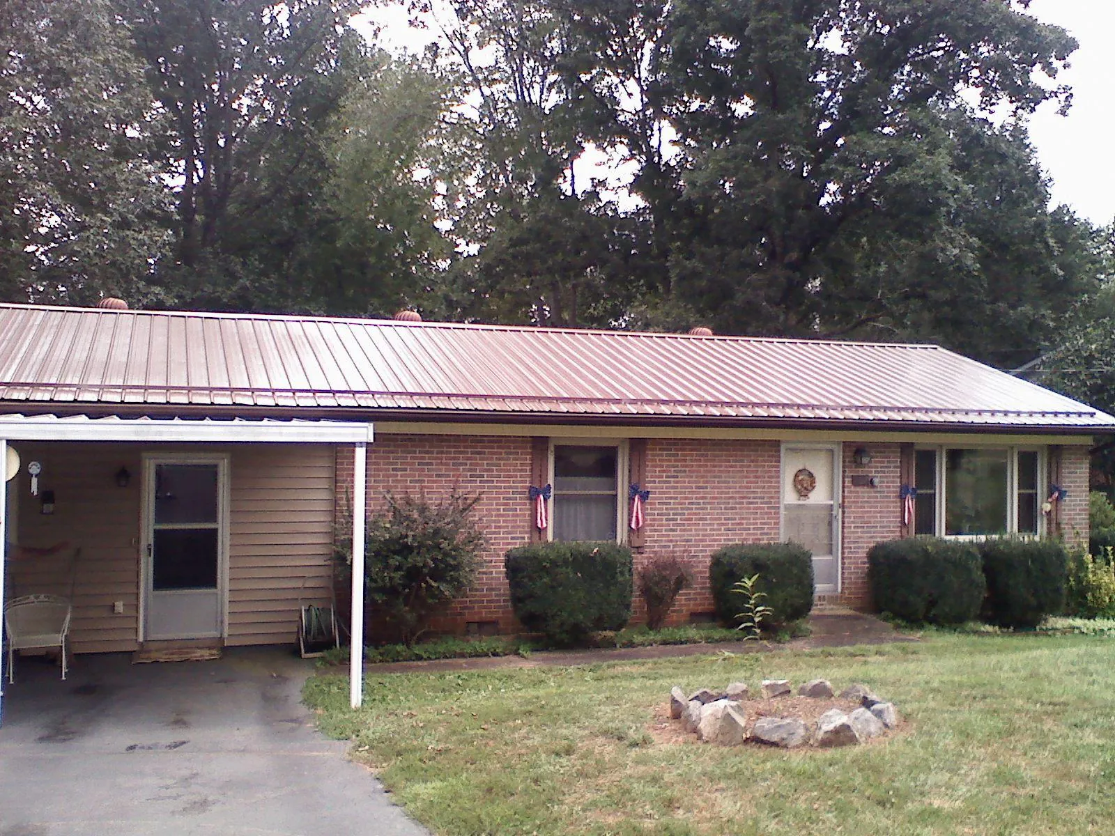 Bronze metal roof and carport on a brick ranch home — Roof Repair work by our crew in Kimballton